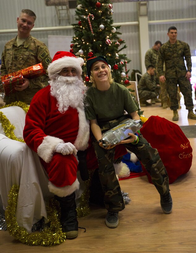 A Romanian boy poses with Santa at a Christmas celebration hosted by U.S. Marines, sailors and soldiers on Mihail Kogalniceanu Air Base, Romania, Dec. 19, 2015. U.S. Marine Corps photo by Lance Cpl. Melanye E. Martinez