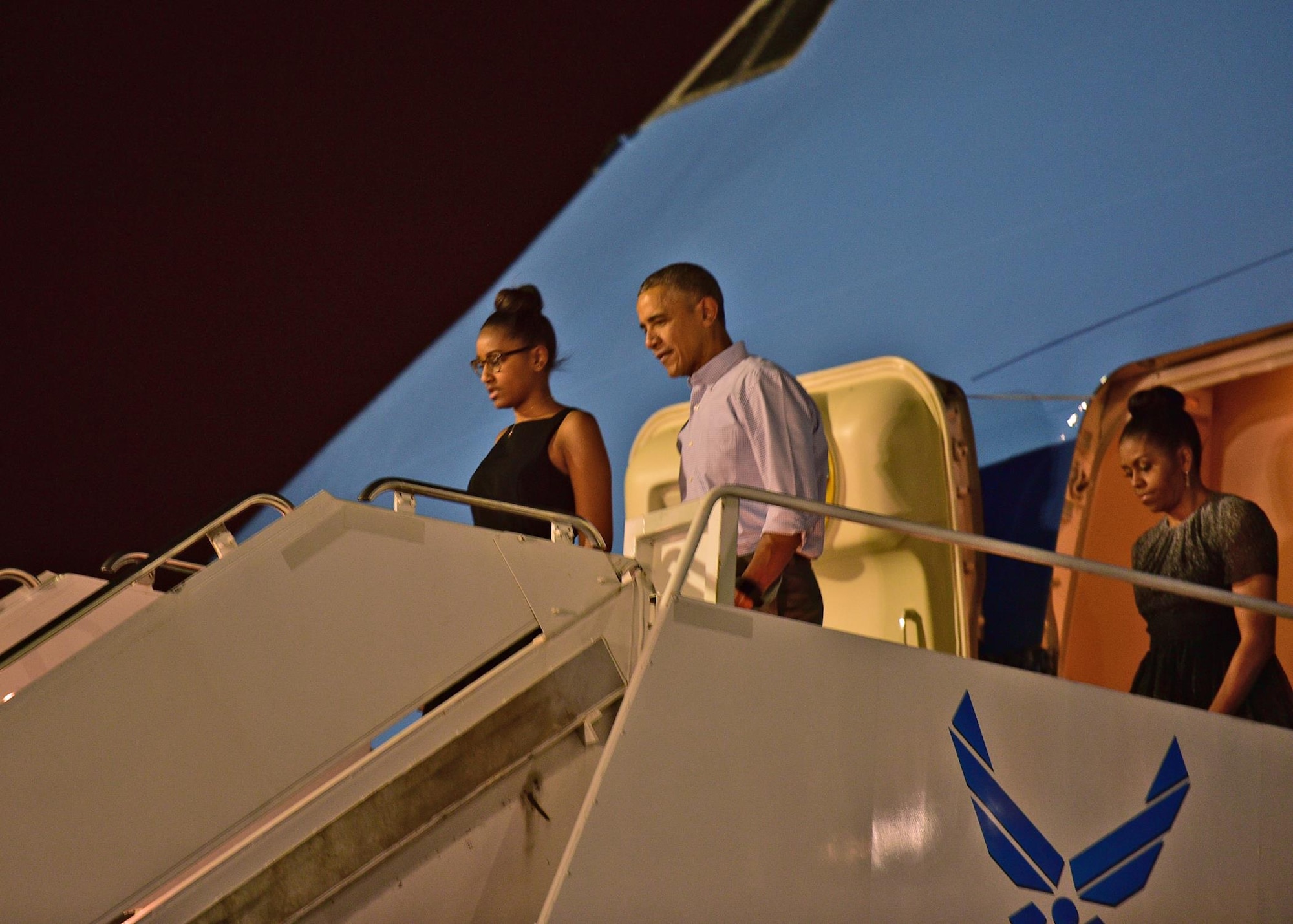 The First Family disembarks Air Force One after landing on Joint Base Pearl Harbor-Hickam, Hawaii, Dec. 18 2015. Airmen from the 15th Wing assisted with planning and preparation of the First Family’s arrival. (U.S. Air Force photo by Tech. Sgt. Aaron Oelrich/Released)