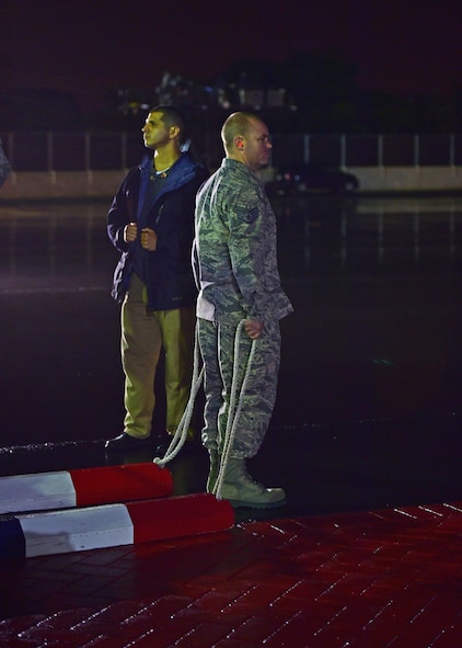 Staff Sgt. Joseph Stamps, from 15th Maintenance Squadron, awaits the arrival of Air Force One as the ceremonial chocker on Joint Base Pearl Harbor-Hickam, Hawaii, Dec. 18 2015. The First Family passed through JBPHH as they begin their annual holiday vacation. Airmen from the 15th Wing assisted with planning and preparation of the First Family’s arrival. (U.S. Air Force photo by Tech. Sgt. Aaron Oelrich/Released)