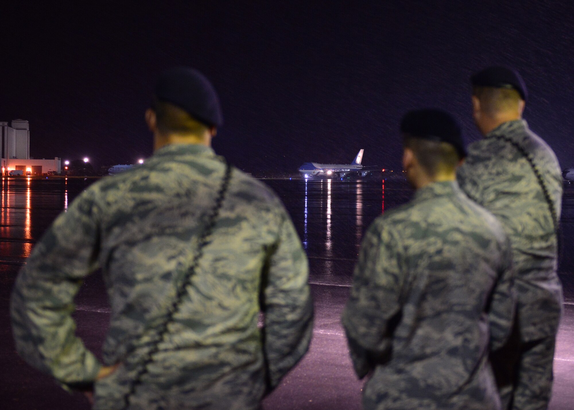 Airmen from the 647th Security Forces Squadron await the arrival of the First Family on Joint Base Pearl Harbor-Hickam, Hawaii, Dec. 18, 2015. The First Family passed through JBPHH as they begin their annual holiday vacation. Airmen from the 15th Wing assisted with planning and preparation of the First Family’s arrival. (U.S. Air Force photo by Tech. Sgt. Aaron Oelrich/Released)