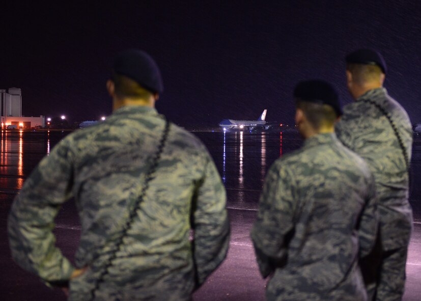 Airmen from the 647th Security Forces Squadron await the arrival of the First Family on Joint Base Pearl Harbor-Hickam, Hawaii, Dec. 18, 2015. The First Family passed through JBPHH as they begin their annual holiday vacation. Airmen from the 15th Wing assisted with planning and preparation of the First Family’s arrival. (U.S. Air Force photo by Tech. Sgt. Aaron Oelrich/Released)