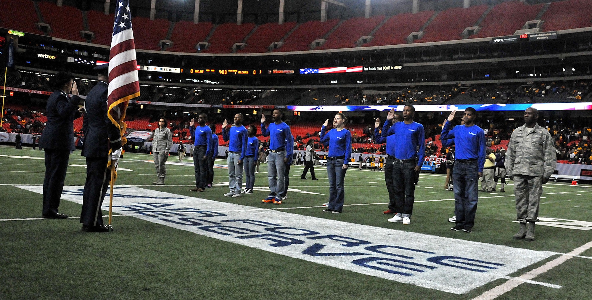 Maj. Gen. Stayce Harris, Commander, 22nd Air Force, swears in a group of airmen recruits at the inaugural Air Force Reserve Celebration Bowl Dec. 19 at the Georgia Dome in Atlanta. These recruits are now officially enlisted in the Air Force Reserve and now await orders to attend Basic Military Training at Joint Base San Antonio Lackland in San Antonio, Texas. (U.S. Air Force photo/Senior Airman Andrew Park)