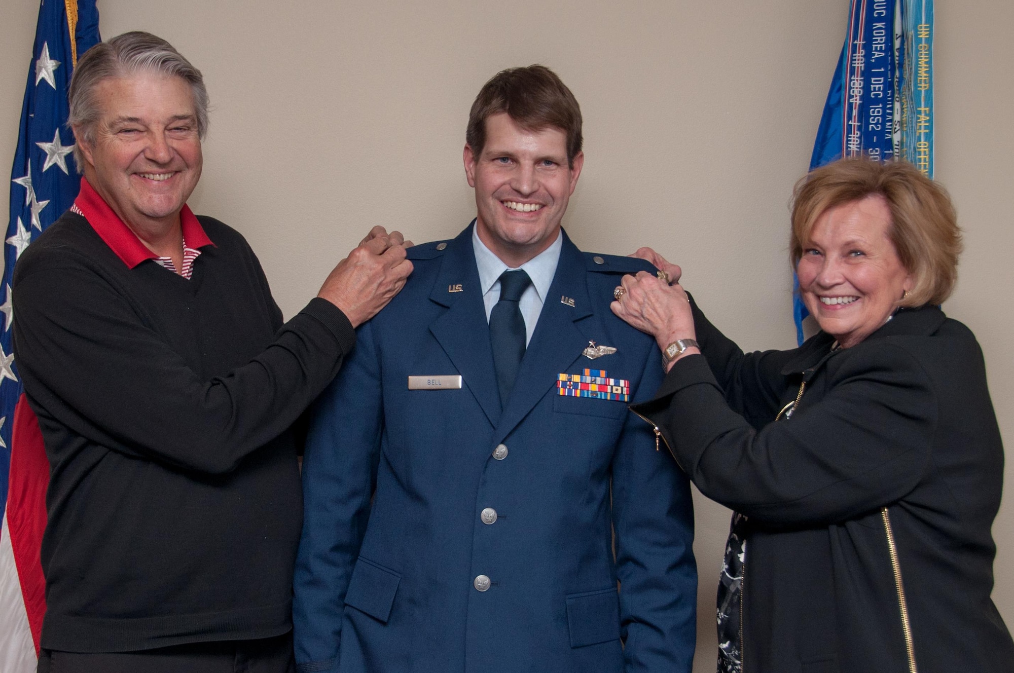 The parents of U.S. Air Force Lt. Col. Landon Bell, 343rd Bomb Squadron Assistant Director of Operations, pin on Lt. Col oak leaves at a promotion ceremony at Barksdale Air Force Base, La, on Dec. 11, 2015. Bell is a navigator in the B-52 Stratafortress. (U.S. Air Force photo by Master Sgt. Laura Siebert/Released)