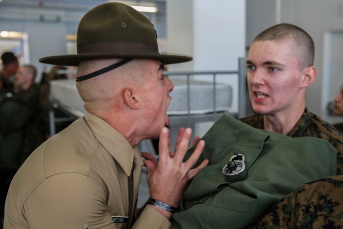 Sergeant Preston T. Brown, India Company, 3rd Recruit Training Battalion, yells at a recruit for not responding loudly enough during pick up at Marine Corps Recruit Depot San Diego, Dec. 18. Pick up is the first encounter the recruits have with the drill instructors who are charged with the responsibility of transforming the recruits into basically trained Marines. Annually, more than 17,000 males recruited from the Western Recruiting Region are trained at MCRD San Diego. India Company is scheduled to graduate March 11.