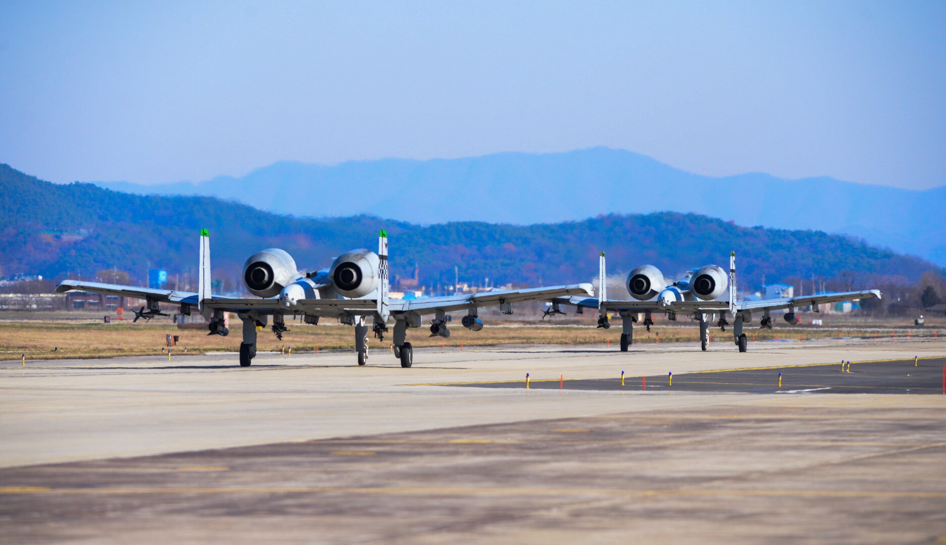 151217-F-LM669-025 OSAN AIR BASE, Republic of Korea (Dec. 17, 2015) A-10 Thunderbolt IIs taxi on the flightline after a forward air control training mission during Buddy Wing 15-8 at Osan Air Base, Republic of Korea, Dec. 17, 2015. U.S. Air Force and ROKAF pilots performed FAC missions simultaneously to ensure interoperability. (U.S. Air Force photo/Airman 1st Class Dillian Bamman)