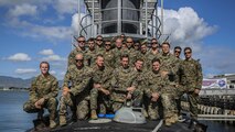 Marines and Sailors with Company A, 1st Reconnaissance Battalion, 1st Marine Division, pose for a photo atop of the USS Mississippi, a Virginia Class Block 5 submarine aboard Joint Base Pearl Harbor-Hickam, Hawaii, Nov. 17, 2015. Company A toured the ship as part of a one-day Special Operations Forces capabilities training event, where they learned about lock-out submarine insertions.
