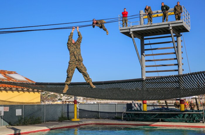 Recruits of Bravo Company, 1st Recruit Training Battalion, participates in the Slide for Life obstacle during Confidence Course II at Marine Corps Recruit Depot San Diego, Dec. 15. This obstacle required great physical endurance for recruits to keep their grip on the cable and make it through without falling. Today, all males recruited west of the Mississippi are trained at MCRD San Diego. The depot is responsible for training more than 16,000 recruits annually. Bravo Company is scheduled to graduate Feb. 12.