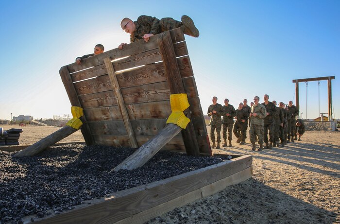 Recruits of Bravo Company, 1st Recruit Training Battalion, climb over a wall during Confidence Course II at Marine Corps Recruit Depot San Diego, Dec. 15. Obstacles in the course included the Monkey Bridge, Skyscraper, Wall Climb and several others. Today, all males recruited west of the Mississippi are trained at MCRD San Diego. The depot is responsible for training more than 16,000 recruits annually. Bravo Company is scheduled to graduate Feb. 12.