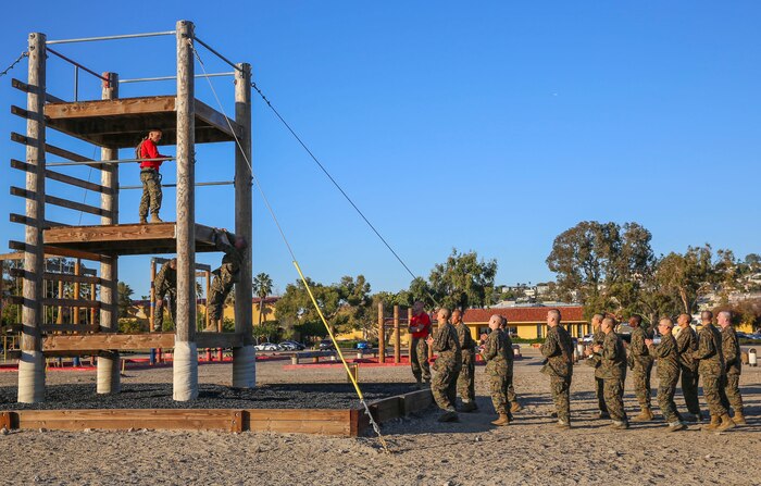 Recruits of Bravo Company, 1st Recruit Training Battalion, climb an obstacle during Confidence Course II at Marine Corps Recruit Depot San Diego, Dec. 15. Drill instructors supervised the exercise and advised the recruits on the technique needed to complete it. Today, all males recruited west of the Mississippi are trained at MCRD San Diego. The depot is responsible for training more than 16,000 recruits annually. Bravo Company is scheduled to graduate Feb. 12.
