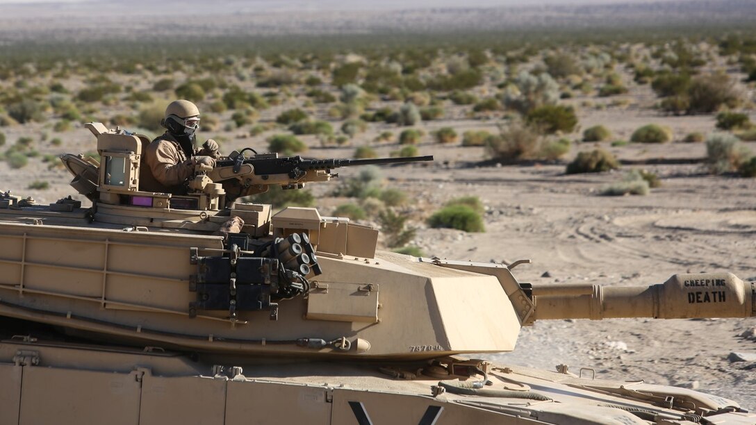 A Marine mans the turret of an M1A1 Abrams tank during the mechanized assault portion of a Marine Corps Combat Readiness Evaluation at Marine Corps Air Ground Combat Center Twentynine Palms, Calif., Dec. 8, 2015. The purpose of a MCCRE is to evaluate Marines’ collective performance in specific mission requirements  that will prepare them for their upcoming deployment rotation. The Marine is with 1st Tank Battalion, 1st Marine Division. (U.S. Marine Corps photo by Lance Cpl. Devan K. Gowans)