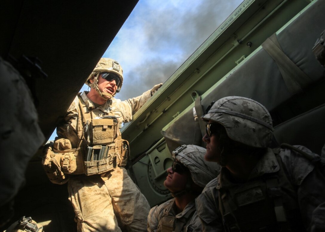 Sgt. Adam C. Bragg relays instruction to his team prior to disembarking an amphibious assault vehicle during the mechanized assault portion of a Marine Corps Combat Readiness Evaluation at Marine Corps Air Ground Combat Center Twentynine Palms, Calif., Dec. 10, 2015. The purpose of a MCCRE is to evaluate Marines’ collective performance in specific mission requirements that will prepare them for their upcoming deployment rotation. Sgt. Bragg is a team leader with 2nd Battalion, 7th Marine Regiment, 1st Marine Division. (U.S. Marine Corps photo by Lance Cpl. Devan K. Gowans)