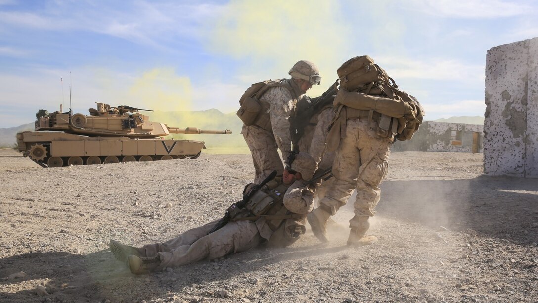 Marines drag a simulated casualty to safety during the mechanized assault portion of a Marine Corps Combat Readiness Evaluation at Marine Corps Air Ground Combat Center Twentynine Palms, Calif., Dec. 10, 2015. The purpose of a MCCRE is to evaluate Marines’ collective performance in requisite specific combat operationsmission requirements that will prepare them for their upcoming deployment rotations. The Marines are with 2nd Battalion, 7th Marine Regiment, 1st Marine Division. (U.S. Marine Corps photo by Lance Cpl. Devan K. Gowans)