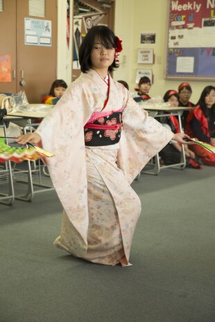 Yuki Kintanaka, a student at Bunkyo Women’s University in Hiroshima, Japan, performs a traditional dance for Matthew C. Perry High School students at Marine Corps Air Station Iwakuni, Nov. 23, 2015. Bunkyo Women’s University students visited the station to learn about American culture as well as teach the American students a little about their own. School trips like this help the bond between Japan and the U.S. grow stronger.
