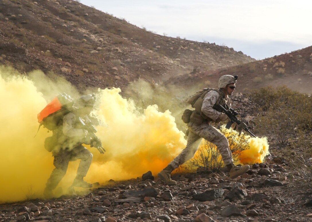 Marines run through the obstruction of smoke during the company supported, live-fire assault portion of a Marine Corps Combat Readiness Evaluation at Marine Corps Air Ground Combat Center Twentynine Palms, Calif., Dec. 6, 2015. The purpose of a MCCRE is to evaluate Marines’ collective performance in specific mission requirements that will prepare them for their upcoming deployment rotation. The Marines are with 2nd Battalion, 7th Marine Regiment, 1st Marine Division. (U.S. Marine Corps photo by Lance Cpl. Devan K. Gowans)