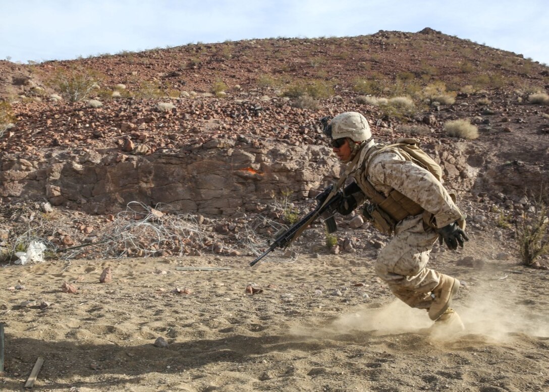 A Marine darts for cover during a company supported, live-fire assault during a Marine Corps Combat Readiness Evaluation at Marine Corps Air Ground Combat Center Twentynine Palms, Calif., Dec. 7, 2015. The purpose of a MCCRE is to evaluate Marines’ collective performance in specific mission requirements that will prepare them for their upcoming deployment rotation.The Marine is with 2nd Battalion, 7th Marine Regiment, 1st Marine Division. (U.S. Marine Corps photo by Lance Cpl. Devan K. Gowans)