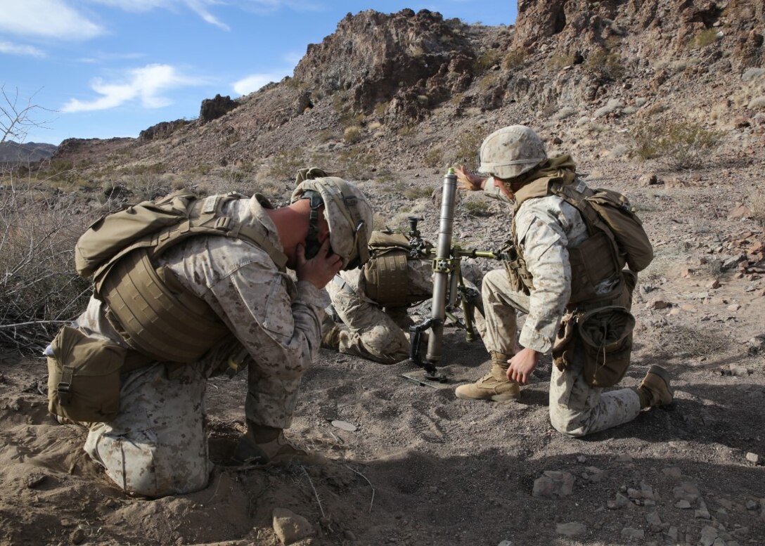 Marines engage simulated targets with an M224 mortar system during a company supported, live-fire assault as part of a Marine Corps Combat Readiness Evaluation at Marine Corps Air Ground Combat Center Twentynine Palms, Calif., Dec. 7, 2015. The purpose of a MCCRE is to evaluate Marines’ collective performance in specific mission requirements that will prepare them for their upcoming deployment rotation. The Marines are with Company F, 2nd Battalion, 7th Marine Regiment, 1st Marine Division. (U.S. Marine Corps photo by Lance Cpl. Devan K. Gowans)