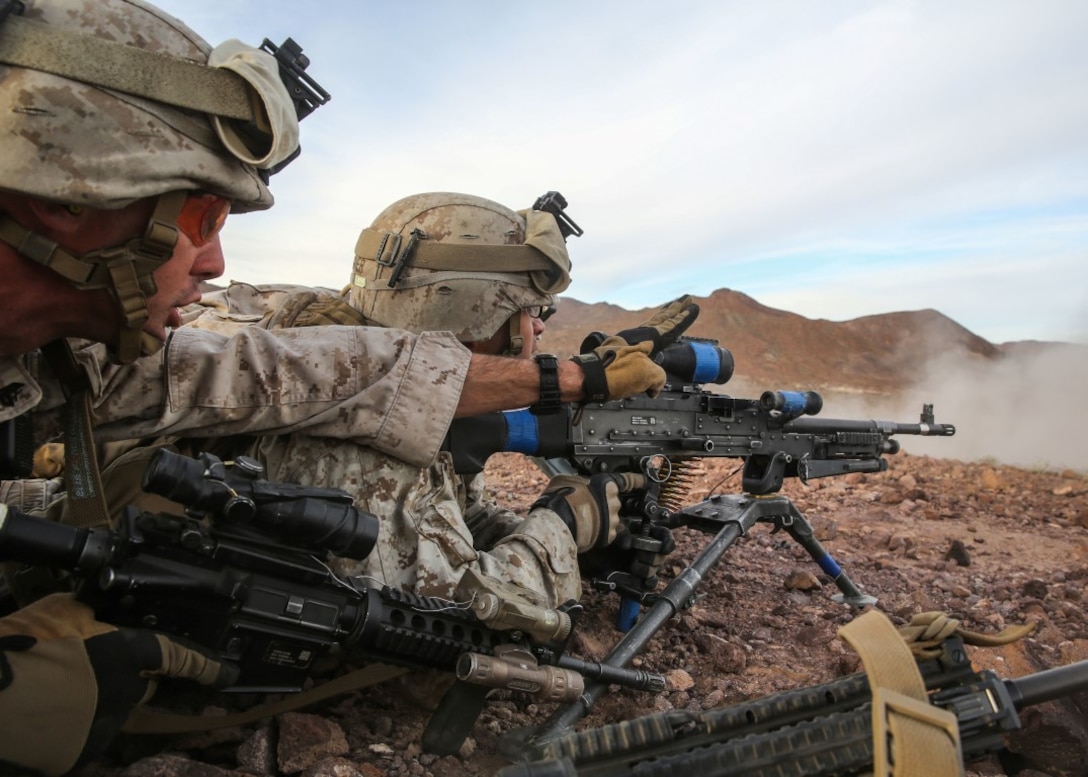 Cpl. Garrett Schroll gives instructions to a member of his team during the company supported, live-fire assault portion of a Marine Corps Combat Readiness Evaluation at Marine Corps Air Ground Combat Center Twentynine Palms, Calif., Dec. 6, 2015. The purpose of a MCCRE is to evaluate Marines’ collective performance in specific mission requirements that will prepare them for their upcoming deployment rotation. Schroll is a machine gunner with Company W, 2nd Battalion, 7th Marine Regiment, 1st Marine Division. (U.S. Marine Corps photo by Lance Cpl. Devan K. Gowans)