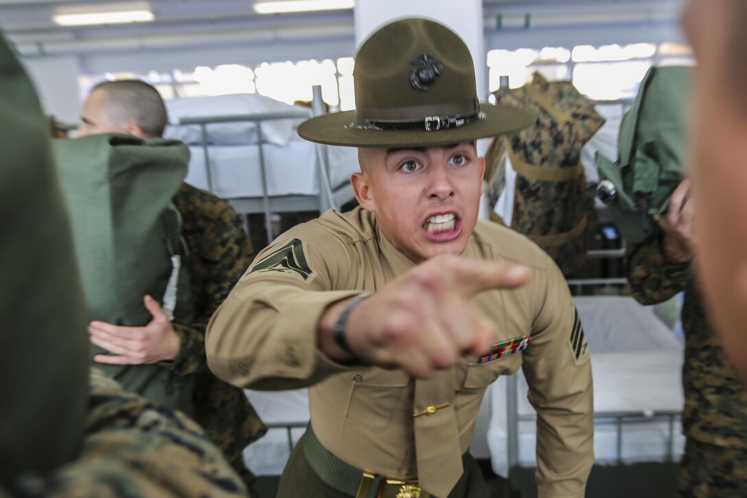 Marine Corps Sgt. Preston T. Brown instructs a recruit to respond louder while ensuring recruits have all required gear for training on Marine Corps Recruit Depot San Diego, Dec. 18, 2015. Brown is assigned to India Company, 3rd Recruit Training Battalion. Marine Corps photo by Sgt. Tyler Viglione 