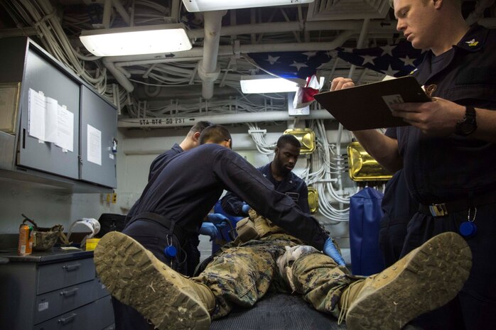 At sea. (Dec. 15, 2015) -U.S Navy corpsmen treat an injured Marine as Marines and Sailors with the 13th Marine Expeditionary Unit (MEU) and Boxer Amphibious Ready Group, conduct a simulated casualty evacuation as part of an ongoing amphibious assault during certification exercise (CERTEX), at sea, Dec. 15, 2015.  CERTEX is the final evaluation of the 13th MEU prior to deployment and is intended to certify their readiness to conduct missions across the full spectrum of military operations. (U.S Marine Corps photo by Cpl. Briauna Birl/RELEASED)