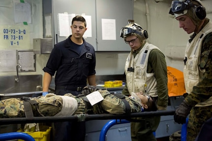 At sea. (Dec. 15, 2015) -A U.S Marine with the 13th Marine Expeditionary Unit (MEU), is transported to the USS Boxer's patient care facility as Marines and Sailors conduct a simulated casualty evacuation as part of an ongoing amphibious assault during certification exercise (CERTEX), at sea, Dec. 15, 2015.  CERTEX is the final evaluation of the 13th MEU prior to deployment and is intended to certify their readiness to conduct missions across the full spectrum of military operations. (U.S Marine Corps photo by Cpl. Briauna Birl/RELEASED)