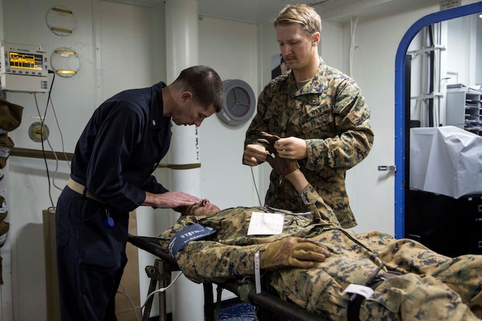 At sea. (Dec. 15, 2015) -A U.S Marine with the 13th Marine Expeditionary Unit (MEU), is checked by Navy medical staff as they participate in a simulated casualty evacuation as part of an ongoing amphibious assault during certification exercise (CERTEX), at sea, Dec. 15, 2015.  CERTEX is the final evaluation of the 13th MEU prior to deployment and is intended to certify their readiness to conduct missions across the full spectrum of military operations. (U.S Marine Corps photo by Cpl. Briauna Birl/RELEASED)