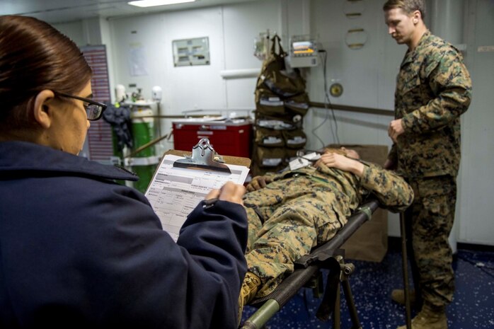 At sea. (Dec. 15, 2015) -A U.S Sailor with the 13th Marine Expeditionary Unit (MEU) and Boxer Amphibious Ready Group, fills in a patients information as Marines and Sailors conduct a simulated casualty evacuation as part of an ongoing amphibious assault during certification exercise (CERTEX), at sea, Dec. 15, 2015.  CERTEX is the final evaluation of the 13th MEU prior to deployment and is intended to certify their readiness to conduct missions across the full spectrum of military operations. (U.S Marine Corps photo by Cpl. Briauna Birl/RELEASED)