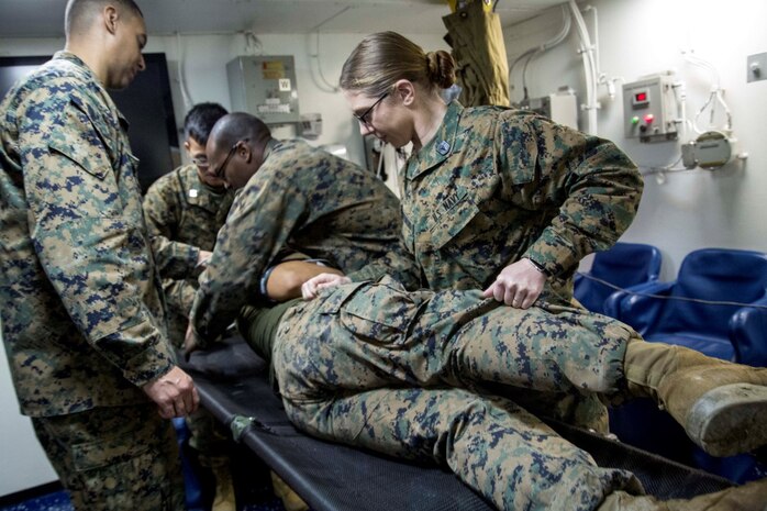 At sea. (Dec. 15, 2015) -U.S Sailors with the 13th Marine Expeditionary Unit (MEU) and Boxer Amphibious Ready Group, check a gun shot patient for exit wounds while conducting a simulated casualty evacuation as part of an ongoing amphibious assault during certification exercise (CERTEX), at sea, Dec. 15, 2015.  CERTEX is the final evaluation of the 13th MEU prior to deployment and is intended to certify their readiness to conduct missions across the full spectrum of military operations. (U.S Marine Corps photo by Cpl. Briauna Birl/RELEASED)
