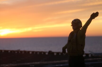 USS BOXER, PACIFIC OCEAN (Dec. 3, 2015)  - A U.S. Navy Sailor with the Boxer Amphibious Ready Group uses hand-and-arm signals to guide an AB-8B Harrier into position on the flight deck of the USS Boxer during flight operations, Dec. 3, 2015. The Boxer Amphibious Ready Group is underway off the coast of Southern California completing a certification exercise. CERTEX is the final evaluation of the 13th Marine Expeditionary Unit and Boxer ARG prior to deployment and is intended to certify their readiness to conduct integrated missions across the full spectrum of military operations. (U.S. Marine Corps photo by Sgt. Paris Capers/ RELEASED)