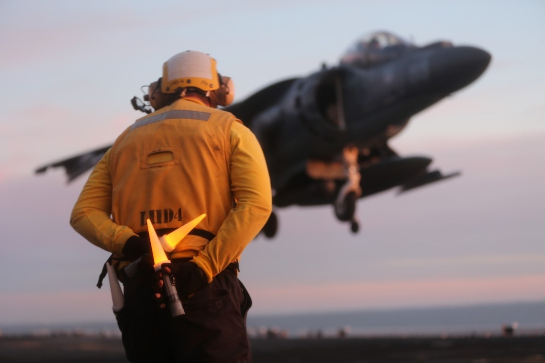 USS BOXER, PACIFIC OCEAN (Dec. 3, 2015)  - A U.S. Navy Sailor with the Boxer Amphibious Ready Group prepares to signal directions to the pilot of an AB-8B Harrier after it lands on the flight deck of the USS Boxer during flight operations, Dec. 3, 2015. The Boxer Amphibious Ready Group is underway off the coast of Southern California completing a certification exercise. CERTEX is the final evaluation of the 13th Marine Expeditionary Unit and Boxer ARG prior to deployment and is intended to certify their readiness to conduct integrated missions across the full spectrum of military operations. (U.S. Marine Corps photo by Sgt. Paris Capers/ RELEASED)