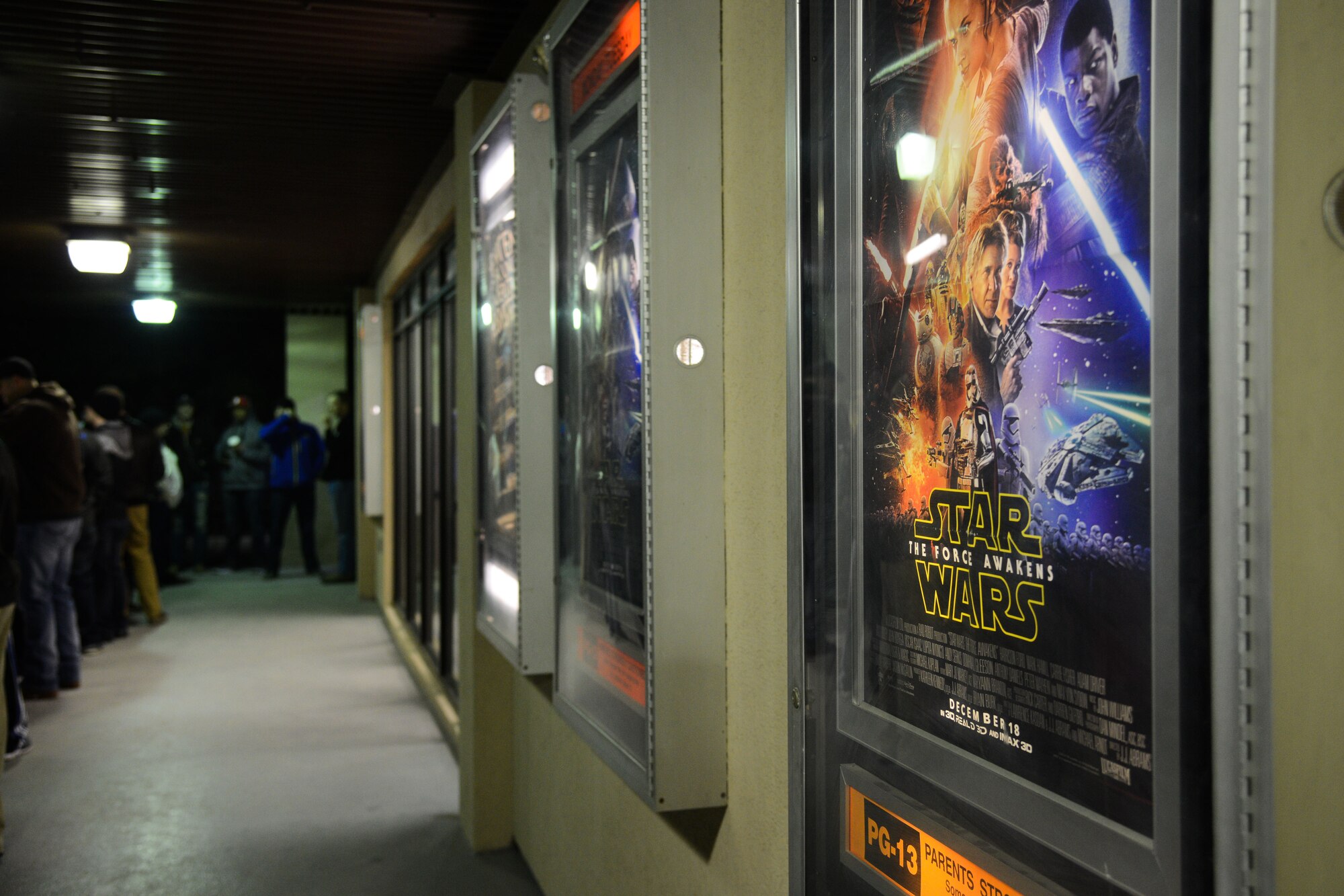 Members of Team Osan wait in line for the premiere of Star Wars: The Force Awakens at Osan Air Base, Republic of Korea, Dec. 18, 2015. The theater reopened Dec. 12, after major renovations with Star Wars being its busiest premiere. (U.S. Air Force photo/Airman 1st Class Dillian Bamman)