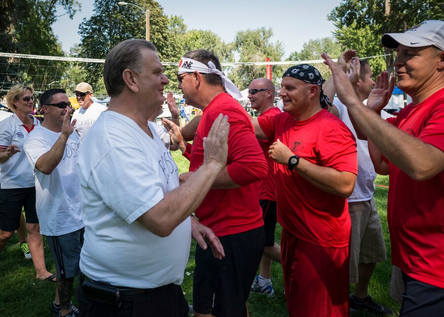 Mountain Home Mayor Tom Rist high-fives leaders from Mountain Home Air Force Base following a base-versus-town volleyball game at Carl Miller Park in Mountain Home, Idaho, Sept. 7, 2013. The game is a yearly staple of Air Force Appreciation Day, an event that has run since 1961. (U.S. Air Force photo by Tech. Sgt. Samuel Morse/RELEASED)