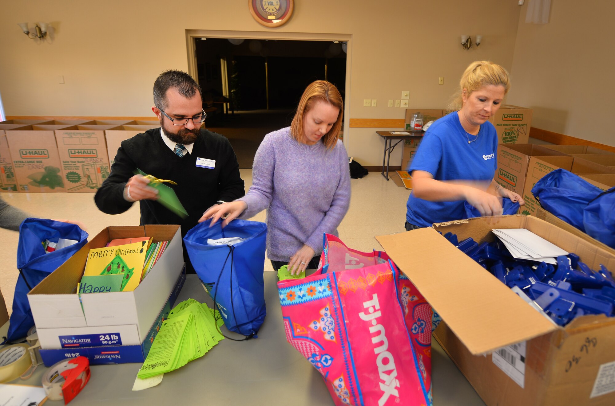 Members of the metro community fill gift bags for Airmen living in the Offutt Air Force Base dormitories on Dec. 17, Bellevue, Neb.  Hundreds of bags were filled as a way to give back and say thanks to the young Airmen living on base.  (U.S. Air Force photo by Josh Plueger)
