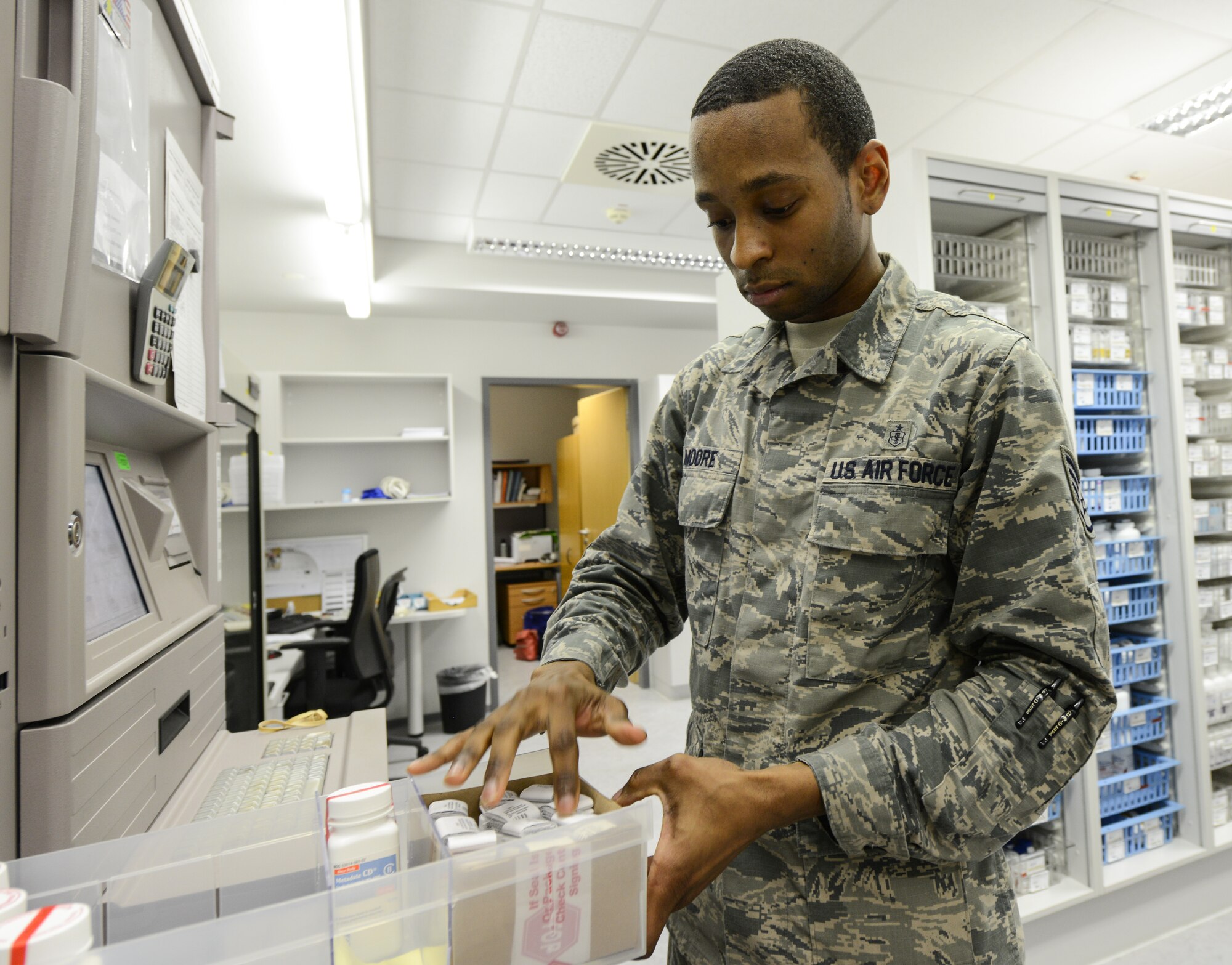 Staff Sgt. Joshua Moore, 86th Medical Support Squadron pharmacy technician, performs his daily task of counting the narcotics in the controlled substance vault, at Ramstein Air Base, Dec. 15. When a patient needs a controlled substance, the pills are counted twice by the technician and once by the pharmacist on duty. (U.S. Air Force photo/Staff Sgt. Leslie Keopka)