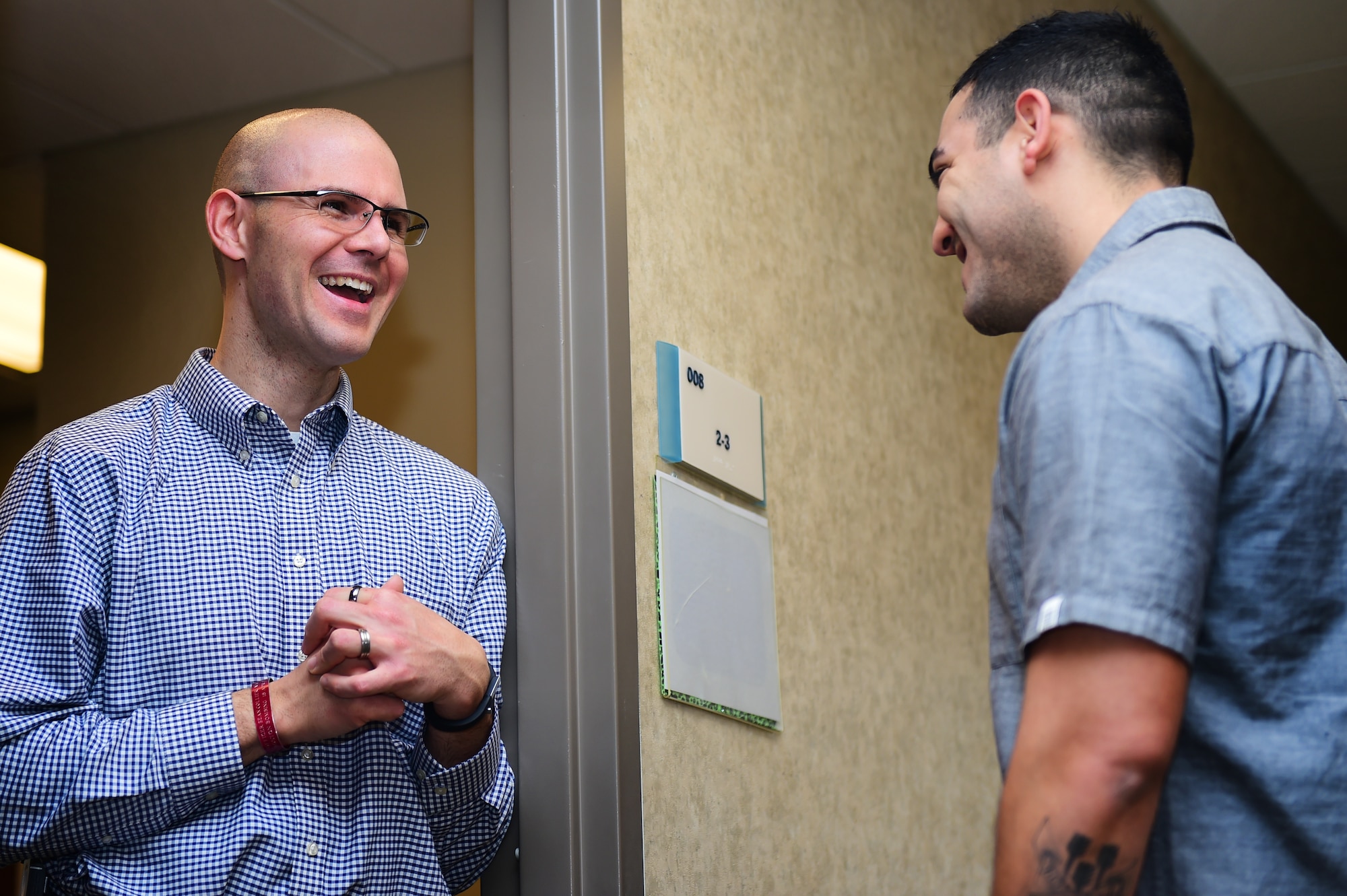 Maj. Jim Bridgham, 140th Wing chaplain, shares a laugh with Senior Airman Ronnie Perez, 460th Medical Operations Squadron medical technician, at the Buckley Chapel Dec. 20, 2015, on Buckley Air Force Base, Colo. Chaplain Bridgham is a unique and charismatic man who prides himself on relating to everyone so that he can help them in the way they need. (U.S. Air Force photo by Airman 1st Class Gabrielle Spradling/Released)