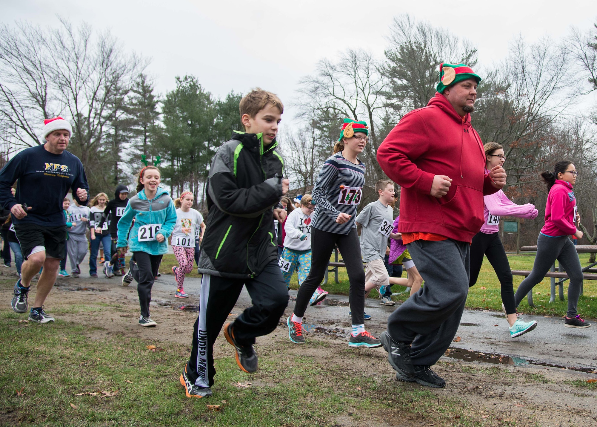 Hanscom Middle School students, parents and teachers participate in the Jingle Bell Run through Castle Park on base Dec. 18. The event was part of the school's annual Hunger Awareness Week. The school raised more than $450 and collected more than 810 pounds of non-perishable items that will be donated to the Merrimack Valley Food Bank throughout the week-long event. (U.S. Air Force photo by Mark Herlihy)