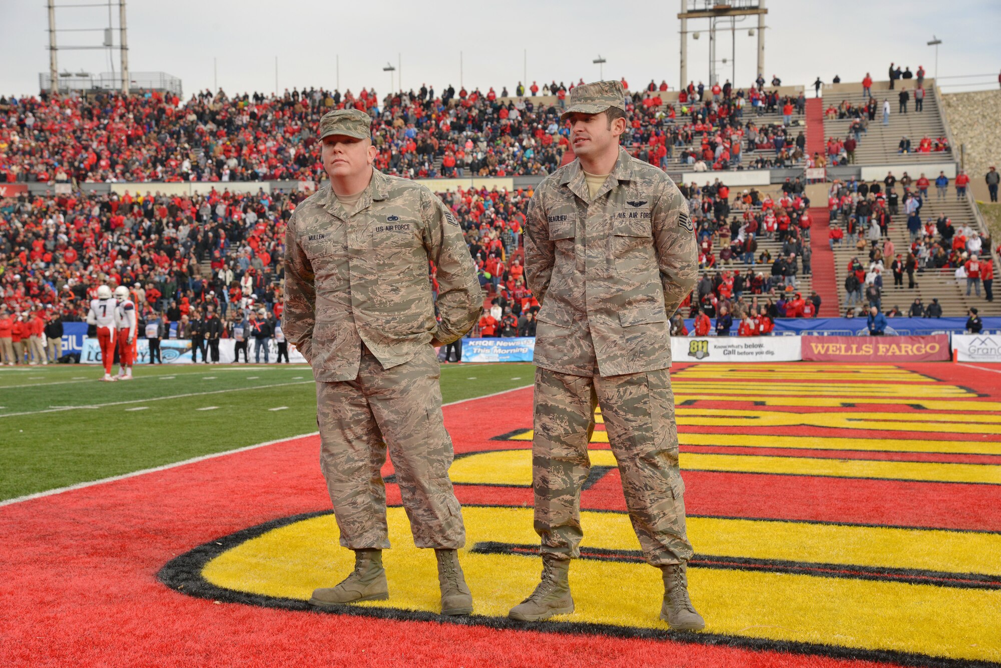 Staff Sgt. Craig Mullen, 58th Aircraft Maintenance Squadron, and Staff Sgt. Travis Beaulieu, 512th Rescue Squadron are recognized for their military accomplishments during the UNM Gildan Bowl Dec. 19. (Photo by Jamie Burnett)