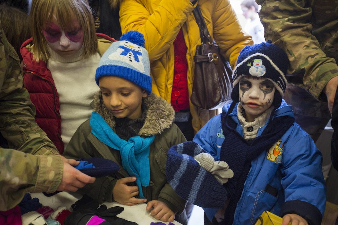 Romanian children celebrate with U.S. service members during a holiday event on Mihail Kogalniceanu Air Base, Romania, Dec. 19, 2015. U.S. Marine Corps photo by Lance Cpl. Melanye E. Martinez