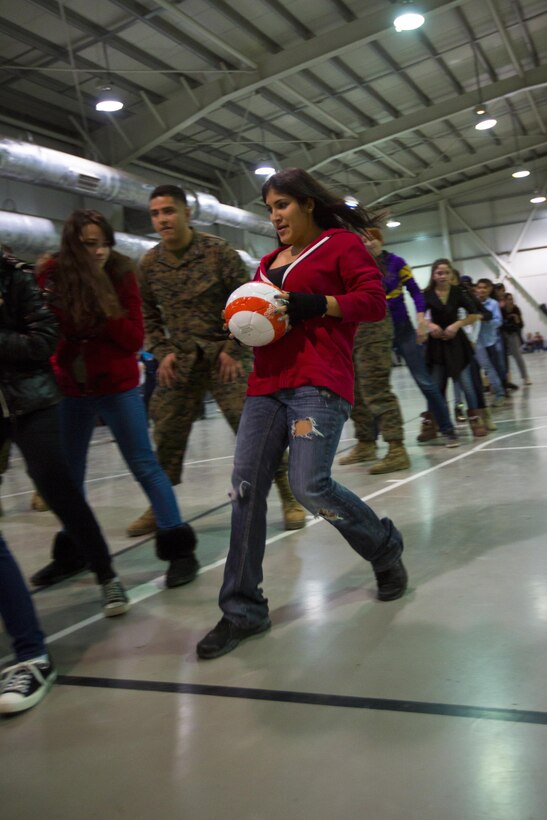 U.S. service members play games with Romanian children during an early Christmas celebration on Mihail Kogalniceanu Air Base, Romania, Dec. 19, 2015. U.S. Marine Corps photo by Lance Cpl. Melanye E. Martinez