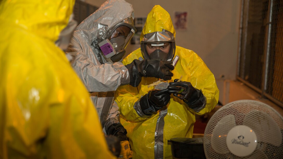 Marines from Marine Wing Support Squadron 171 take chemical samples during Hazardous Waste Operations and Emergency Response training at Marine Corps Air Station Iwakuni, Japan, Dec. 18, 2015. The Marines attended a 40-hour course that taught them how to respond in the case of an emergency and how to operate safely around hazardous materials, waste, substances, and fuels. The Marines conducted classes indoors for three days before exercising practical application for the remainder of the course.