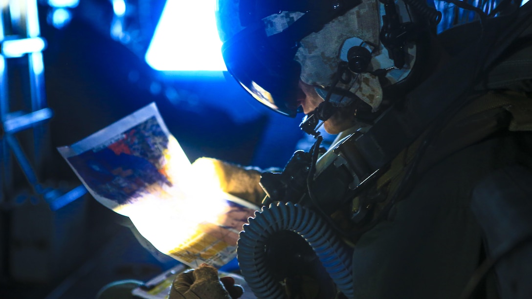 An aircrew member with Marine Medium Tiltrotor Squadron 363 checks a map during an aerial refueling training exercise around Marine Corps Air Station Miramar, California, Dec. 16.  The squadron conducts this annual training once every two months to maintain their proficiency with the maneuvers.