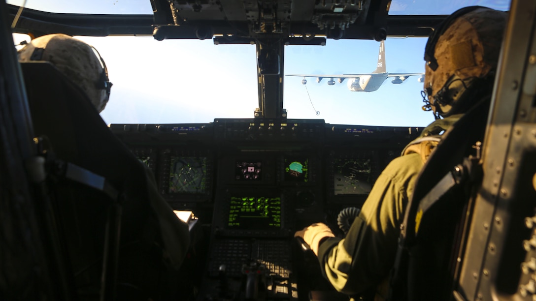 Pilots with Marine Medium Tiltrotor Squadron 363 prepare to dock their MV-22 Osprey to a fuel line from a KC-130J Super Hercules with Marine Aerial Transport Squadron 352 during an aerial refueling exercise around Marine Corps Air Station Miramar, California, Dec. 16. The squadron conducts this annual training once every two months to maintain their proficiency with the maneuvers.