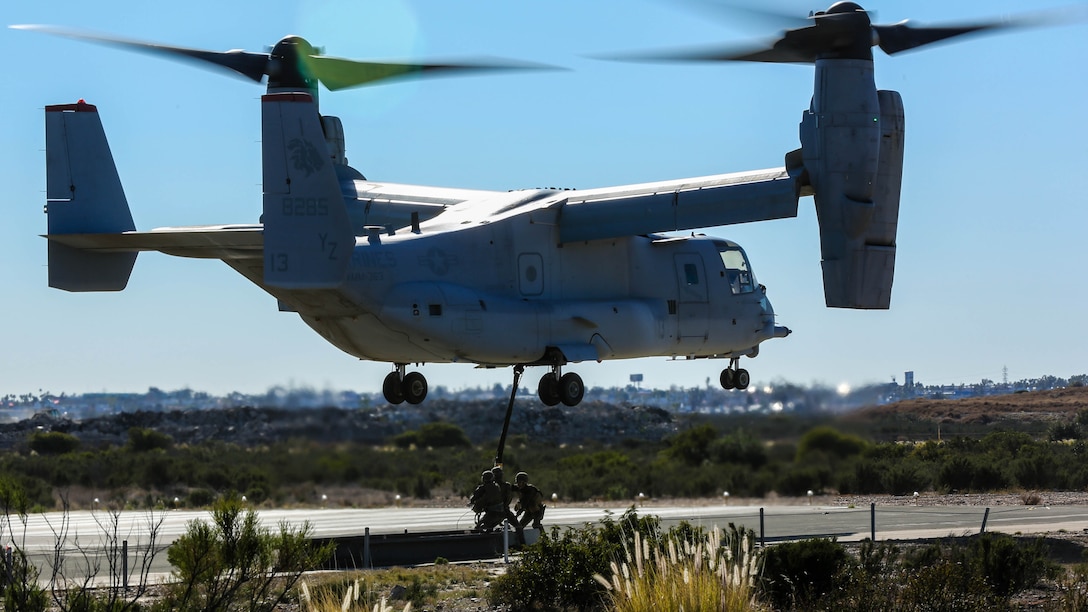 Marines with Combat Logistics Battalion 5 attach a simulated cargo of 1,400 pounds to an MV-22B Osprey with Marine Medium Tiltrotor Squadron 363 aboard Marine Corps Air Station Miramar, Calif., Dec. 16, 2015. Daytime external lift training prepares the Marines with VMM-363 to attach cargo to the aircraft which helps qualify more air crew in the mission-essential task of rapid insertion and extraction for the squadron. 