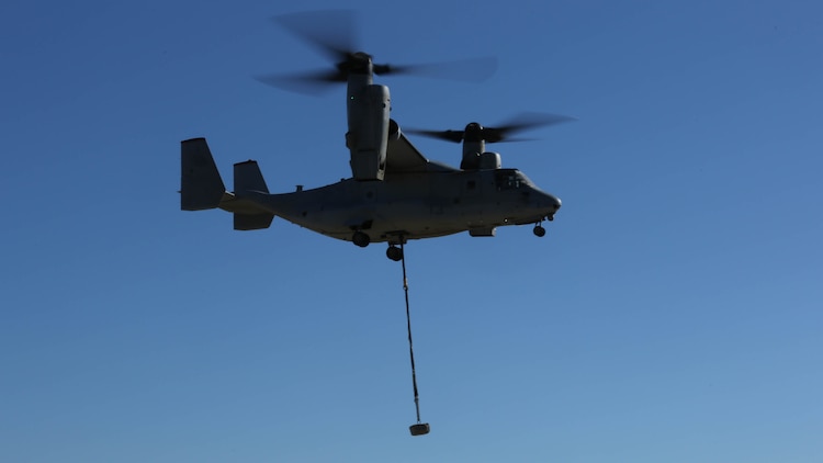 An MV-22B Osprey with Marine Medium Tiltrotor Squadron 363 carries a simulated cargo of 1,400 pounds aboard Marine Corps Air Station Miramar, Calif., Dec. 16, 2015. Daytime external lift training prepares the Marines with VMM-363 to attach cargo to the aircraft which helps qualify more air crew in the mission-essential task of rapid insertion and extraction for the squadron. 