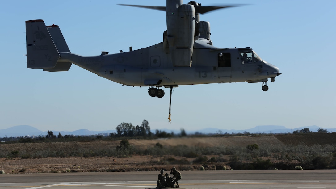 Marines with Combat Logistics Battalion 5 prepare to attach a simulated cargo of 1,400 pounds to an MV-22B Osprey with Marine Medium Tiltrotor Squadron 363 aboard Marine Corps Air Station Miramar, Calif., Dec. 16, 2015. Daytime external lift training prepares the Marines with VMM-363 to attach cargo to the aircraft which helps qualify more air crew in the mission-essential task of rapid insertion and extraction for the squadron. 