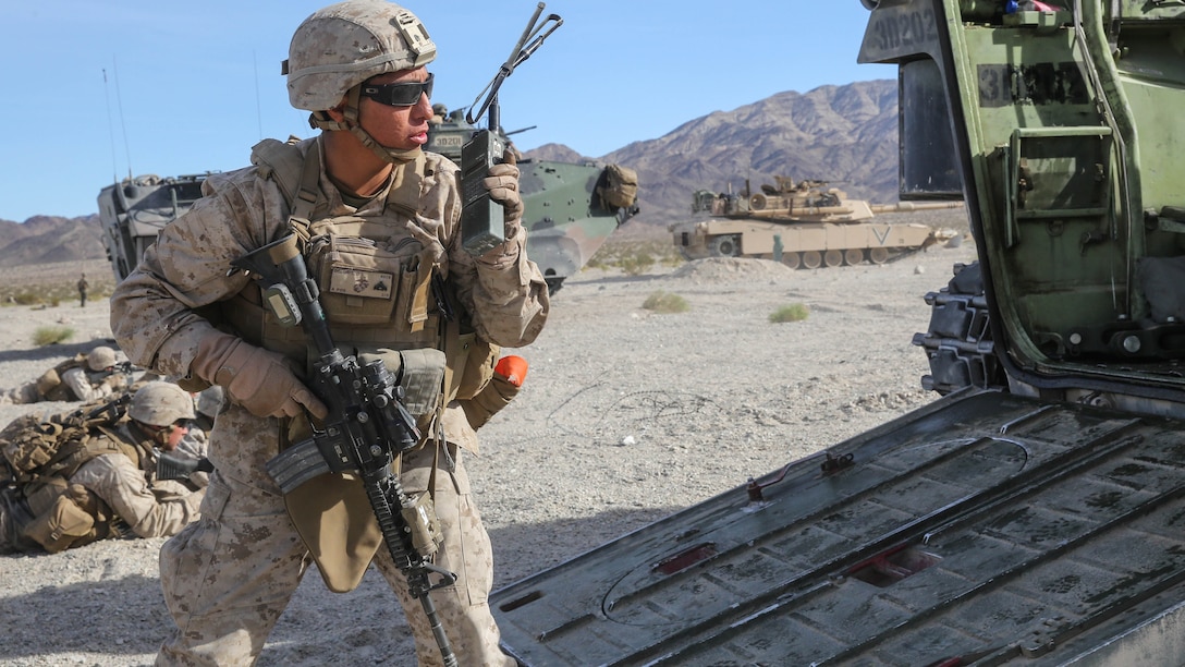 Cpl. Dustin Deloris relays orders over the radio during the mechanized assault portion of the Marine Corps Combat Readiness Evaluation at Marine Corps Air Ground Combat Center Twentynine Palms, Calif., Dec. 8, 2015. The purpose of a MCCRE is to evaluate Marines’ collective performance in specific mission requirements that will prepare them for their upcoming deployment rotation. Deloris is a team leader with Company E, 2nd Battalion, 7th Marine Regiment, 1st Marine Division. 