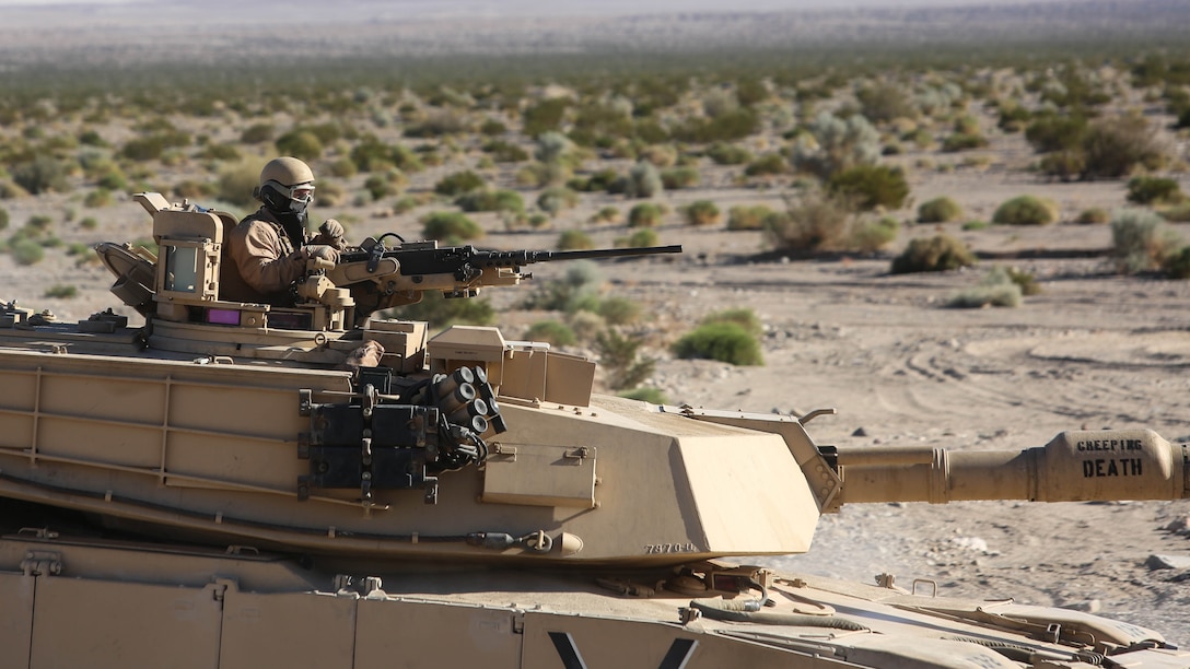 A Marine mans the turret of an M1A1 Abrams tank during the mechanized assault portion of a Marine Corps Combat Readiness Evaluation at Marine Corps Air Ground Combat Center Twentynine Palms, Calif., Dec. 8, 2015. The purpose of a MCCRE is to evaluate Marines’ collective performance in specific mission requirements  that will prepare them for their upcoming deployment rotation. The Marine is with 1st Tank Battalion, 1st Marine Division. 