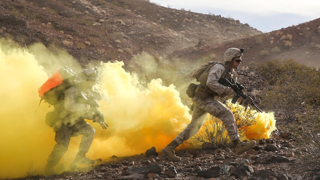 Marines run through the obstruction of smoke during the company supported, live-fire assault portion of a Marine Corps Combat Readiness Evaluation at Marine Corps Air Ground Combat Center Twentynine Palms, California, Dec. 6, 2015. The purpose of a MCCRE is to evaluate Marines’ collective performance in specific mission requirements that will prepare them for their upcoming deployment rotation. The Marines are with 2nd Battalion, 7th Marine Regiment, 1st Marine Division.