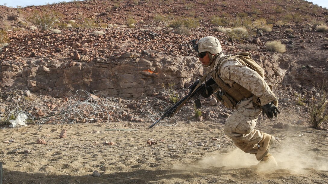 A Marine darts for cover during a company supported, live-fire assault during a Marine Corps Combat Readiness Evaluation at Marine Corps Air Ground Combat Center Twentynine Palms, California, Dec. 7, 2015. The purpose of a MCCRE is to evaluate Marines’ collective performance in specific mission requirements that will prepare them for their upcoming deployment rotation.The Marine is with 2nd Battalion, 7th Marine Regiment, 1st Marine Division.