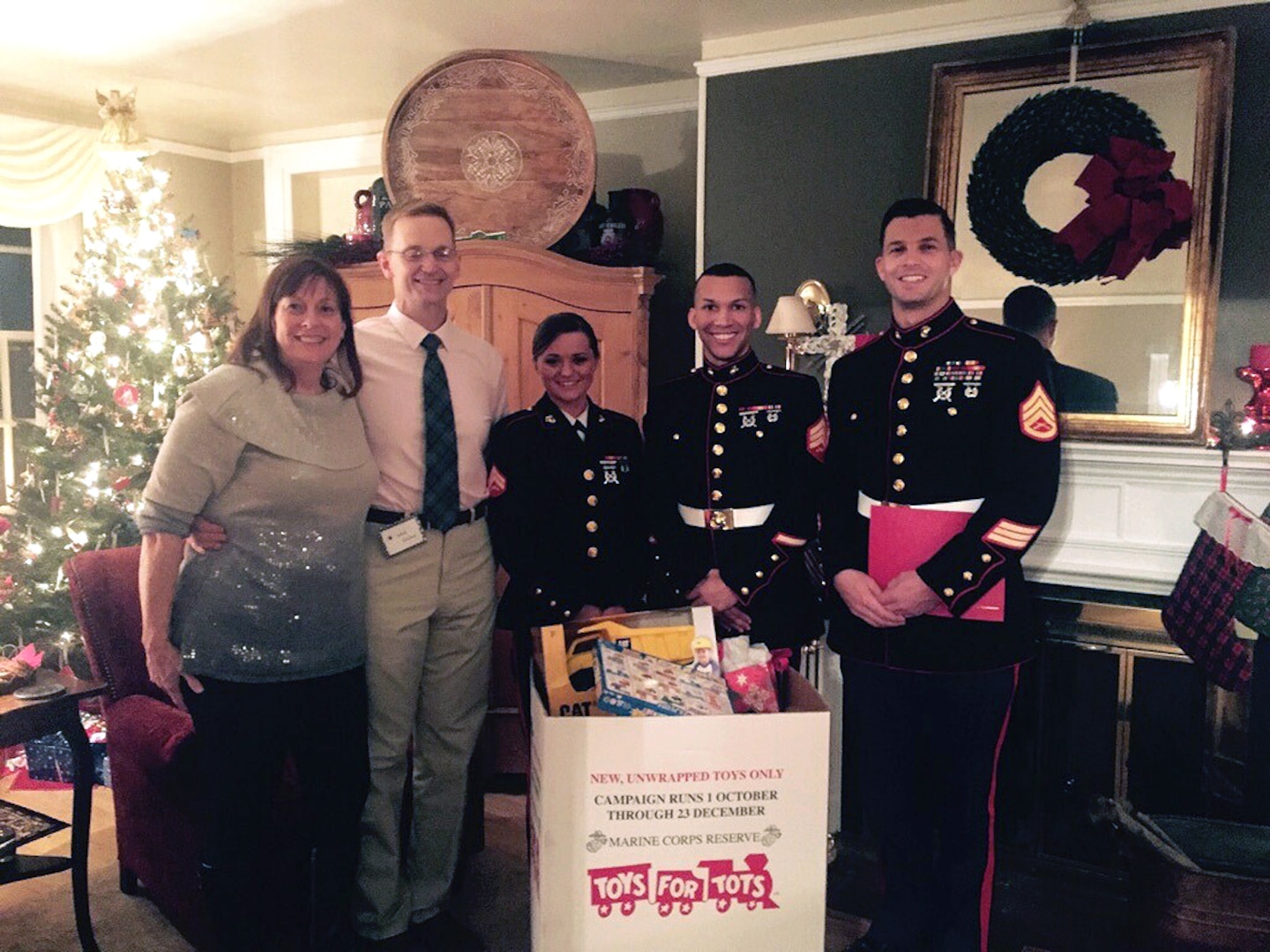 Toys for Tots donations are collected by, from left to right, Laura McLeod, Air Force Brig. Gen. Mark McLeod, Marine Cpl. Chelsea Propes, Marine Sgt. Robert Bradley and Marine Staff Sgt. Andrew Eichelberger. Defense Logistics Agency Energy employees contributed more than 150 toys during the DLA Energy commander’s holiday reception at Fort Belvoir, Virginia, Dec. 19.