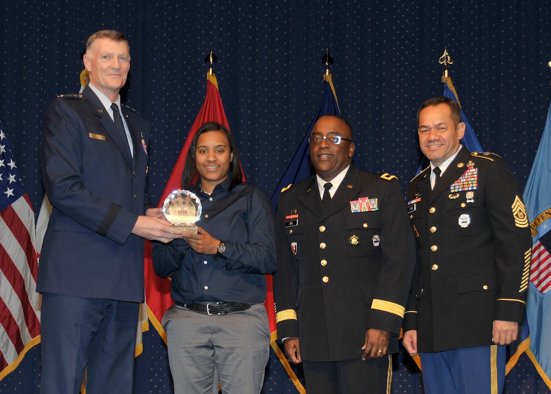 DLA director Air Force Lt. Gen. Andy Busch, left, presents Kareneshia Stubblefield, distribution process worker at Distribution Norfolk, Va., with the Top 10 Employee award at the 48th annual employee recognition ceremony Dec. 10. Distribution’s commander Army Brig. Gen. Richard Dix, second from right, and DLA’s Senior Enlisted Leader Army Command Sgt. Maj. Charles Tobin, right, were also on-hand to present the award.